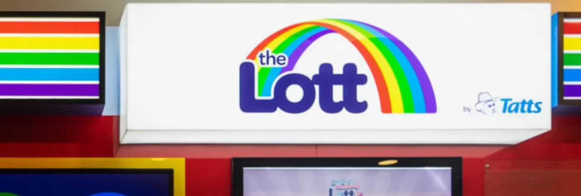 The Lott retail outlet sign beside rainbow-striped light boxes
